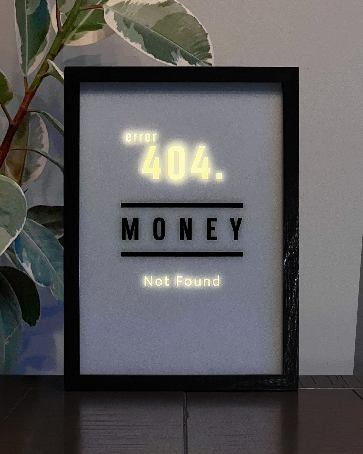 LED Light-up frame with a 'Money' design that transitions to 'Error 404 Not Found' when illuminated, offering a witty and playful twist.