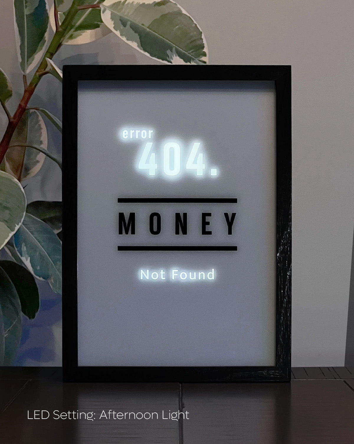 LED Light-up frame with a 'Money' design that transitions to 'Error 404 Not Found' when illuminated, offering a witty and playful twist.