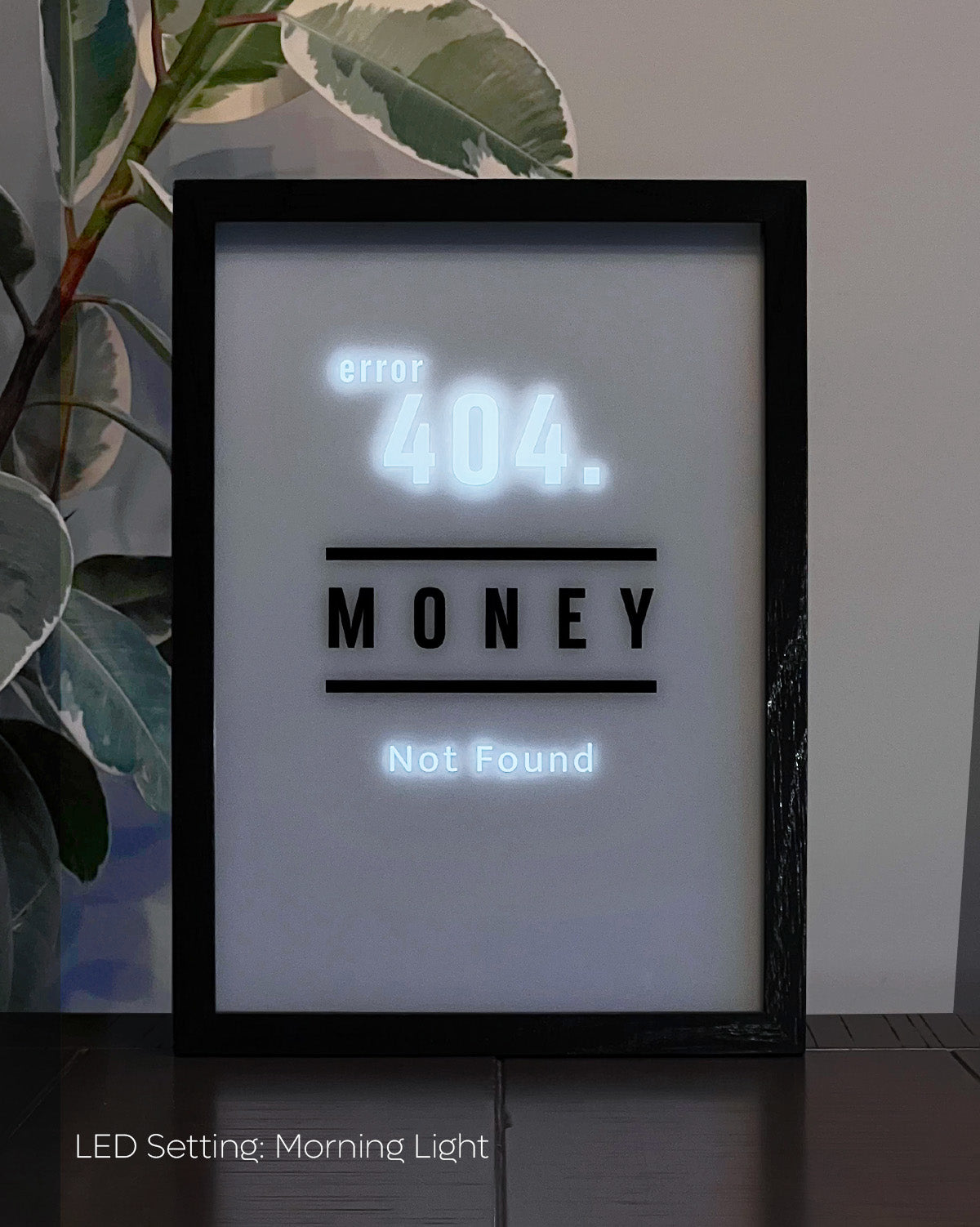 LED Light-up frame with a 'Money' design that transitions to 'Error 404 Not Found' when illuminated, offering a witty and playful twist.