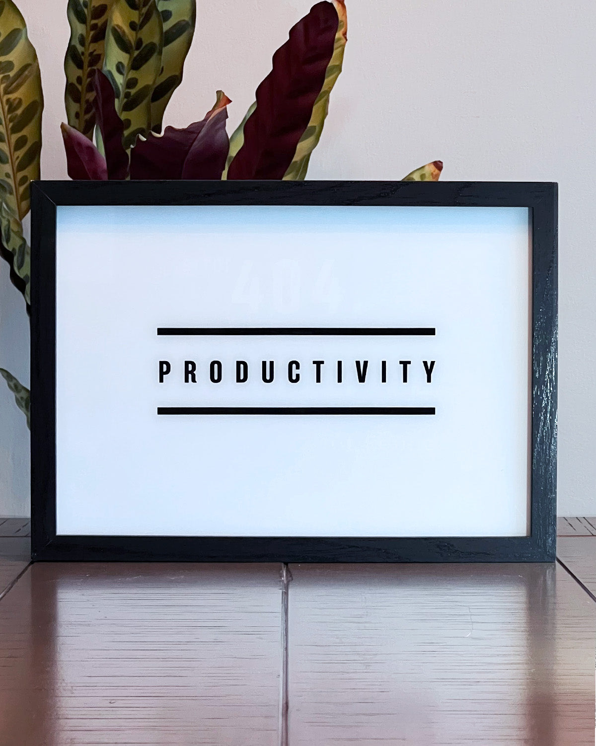 LED Light-up frame featuring the word 'Productivity' with a humorous twist: when illuminated, it reveals the message 'Error 404. Productivity Not Found.' Perfect for workspaces with a touch of sarcasm and wit.