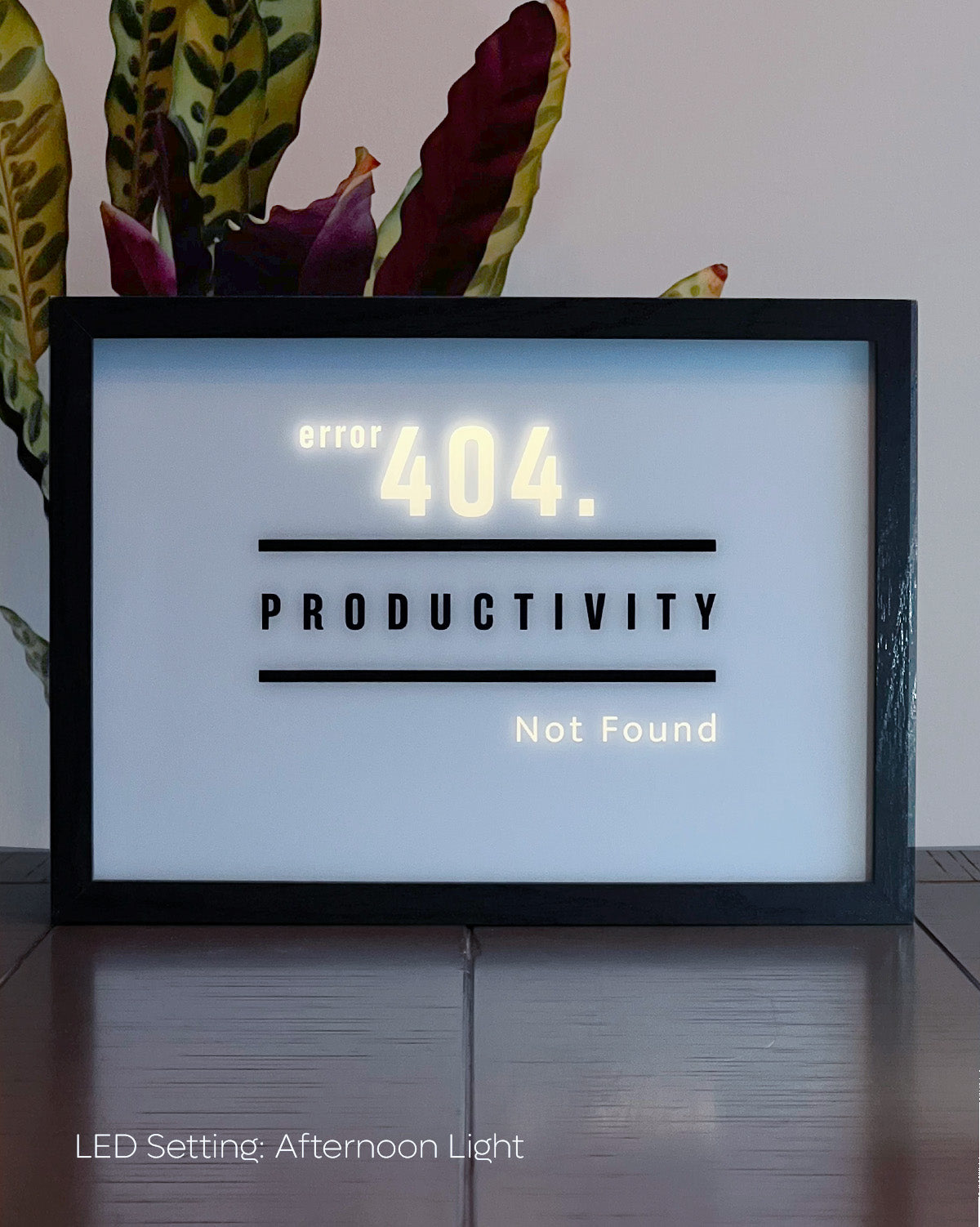 LED Light-up frame featuring the word 'Productivity' with a humorous twist: when illuminated, it reveals the message 'Error 404. Productivity Not Found.' Perfect for workspaces with a touch of sarcasm and wit.