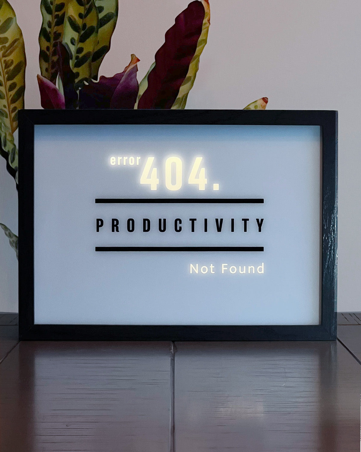 LED Light-up frame featuring the word 'Productivity' with a humorous twist: when illuminated, it reveals the message 'Error 404. Productivity Not Found.' Perfect for workspaces with a touch of sarcasm and wit.
